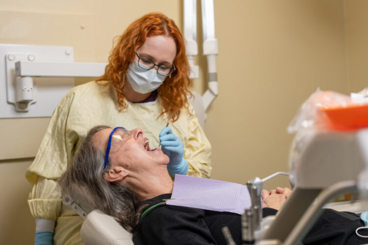 Dr. Waldeck inspects a patient's teeth