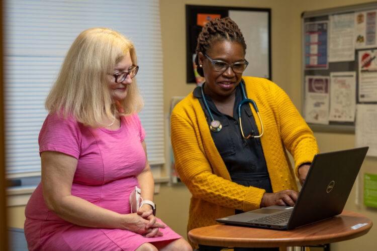 Dr. Duvilaire reviews a patient's chart